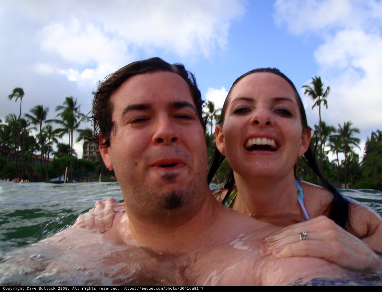 Couple Laughing Together in Hawaiian Ocean Waters