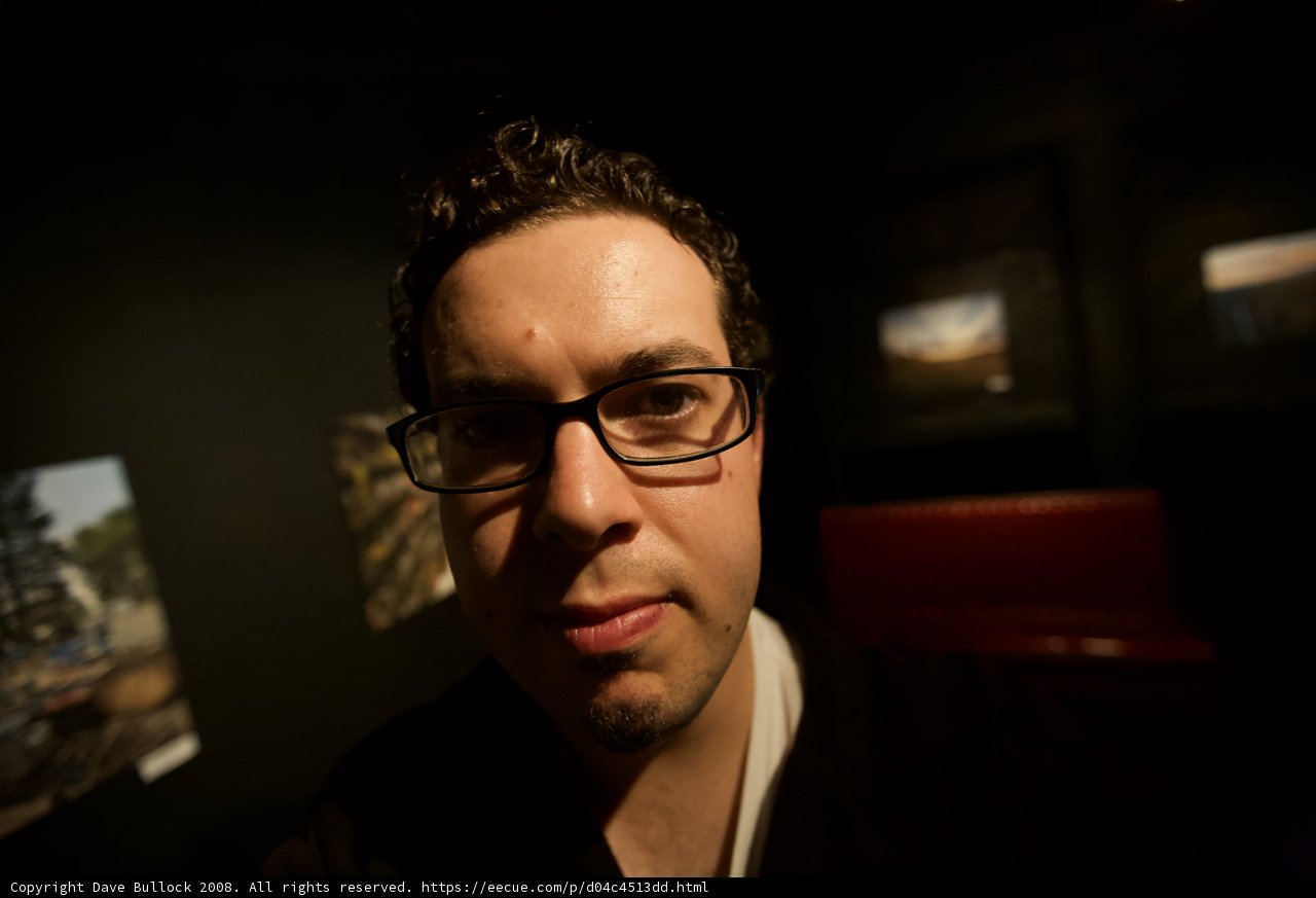 Portrait of a Happy Man in Glasses at Art Gallery