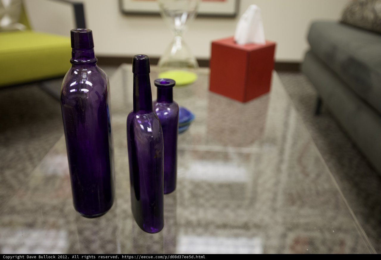 Purple Bottles on Glass Table