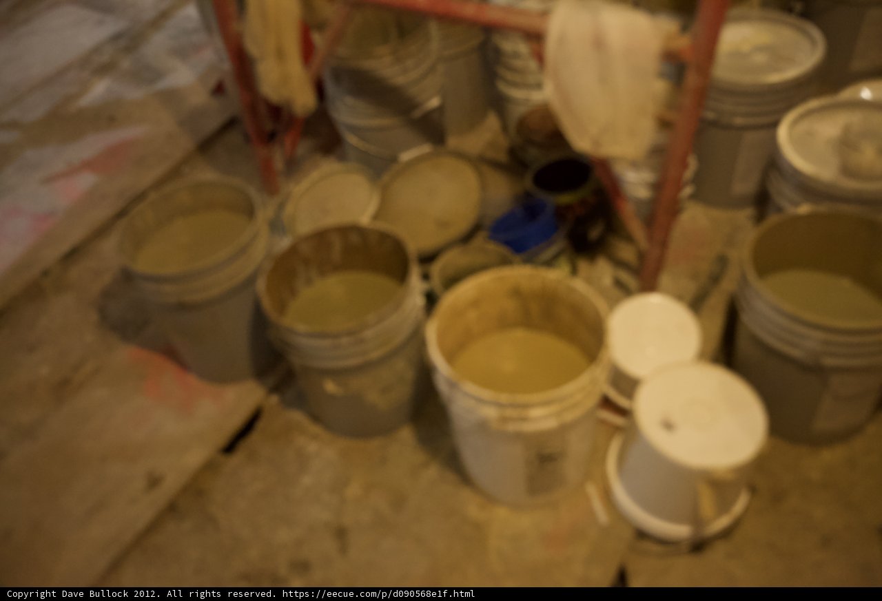 A Messy Pile of Buckets and Paint Cans