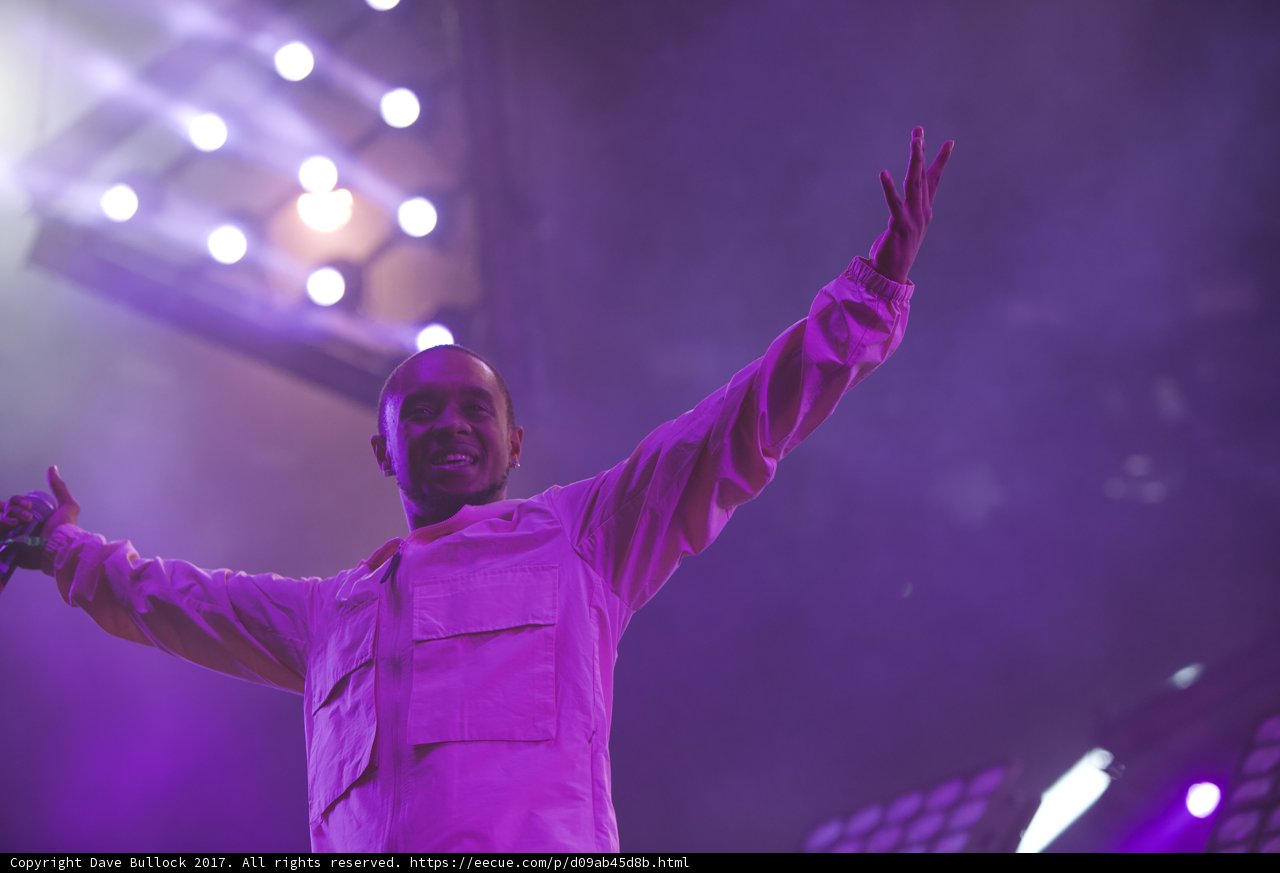 Man in White Shirt Basks in Purple Spotlight