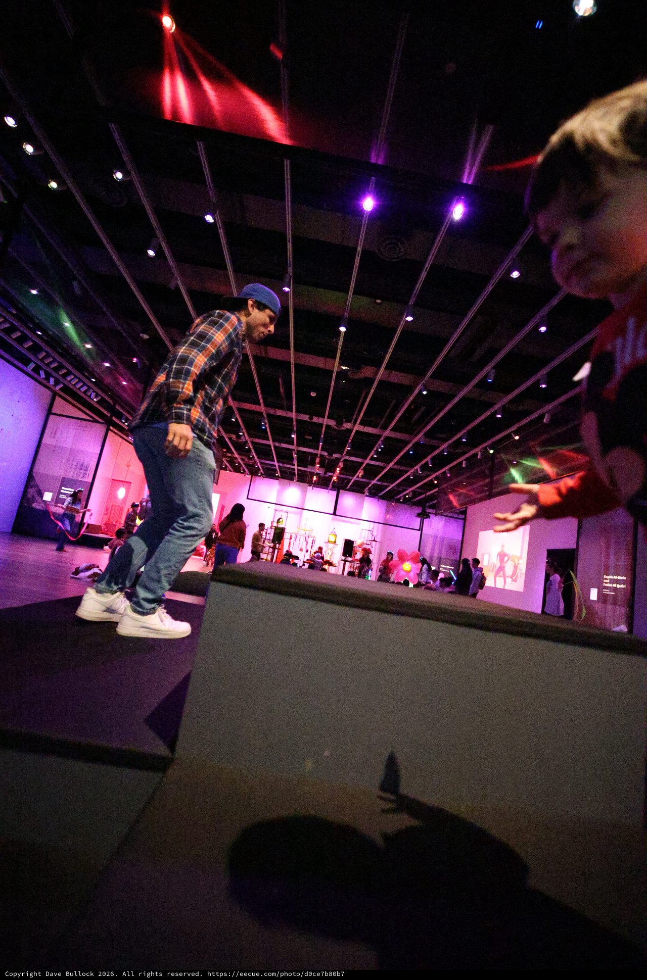 Dynamic Breakdancer at Baby Rave Under Purple Lights
