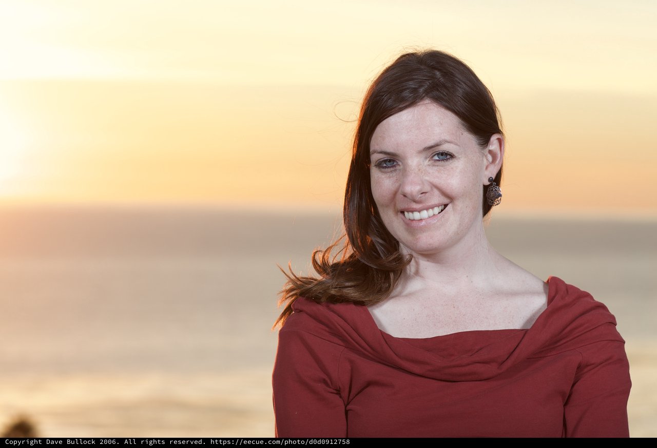 Smiling Woman at Golden Hour Coastal Sunset