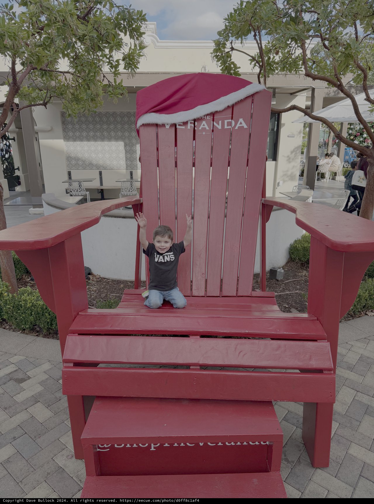 Child Playing in Giant Red Adirondack Chair