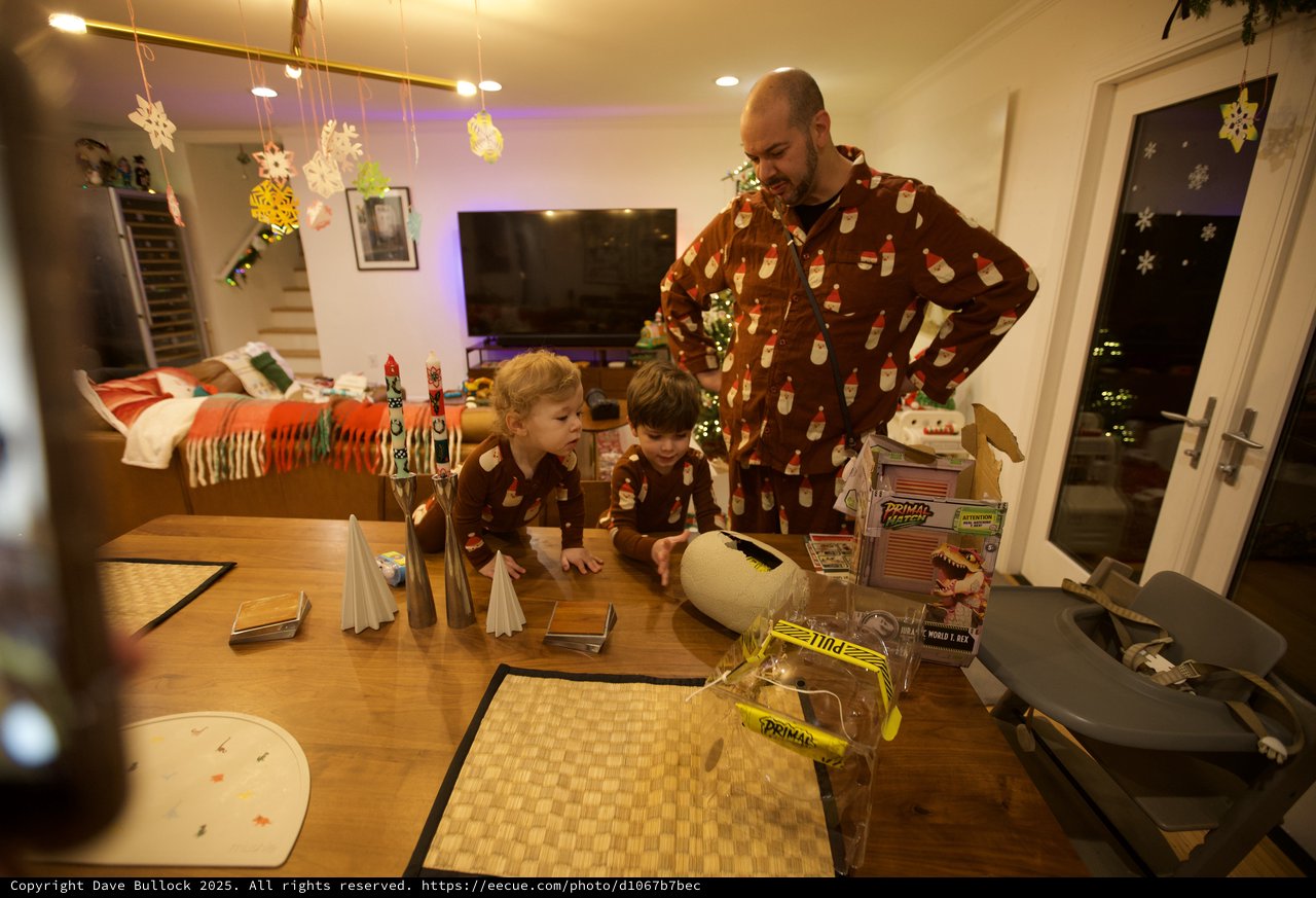 Father and Children in Matching Pajamas at Christmas Table