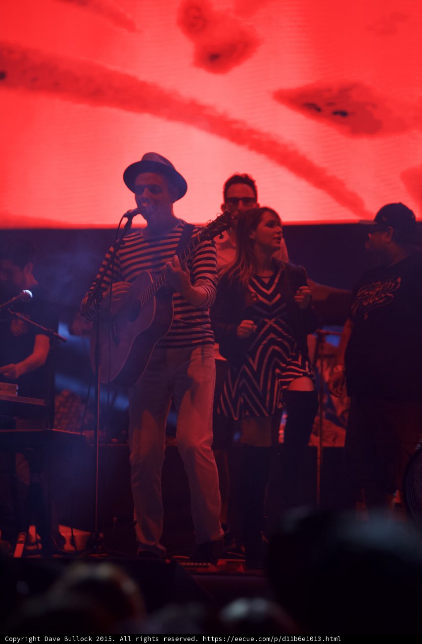 Belle and Sebastian Stuart Murdoch Acoustic Guitar Woman Chevron Dress Looking At Him Red Stage