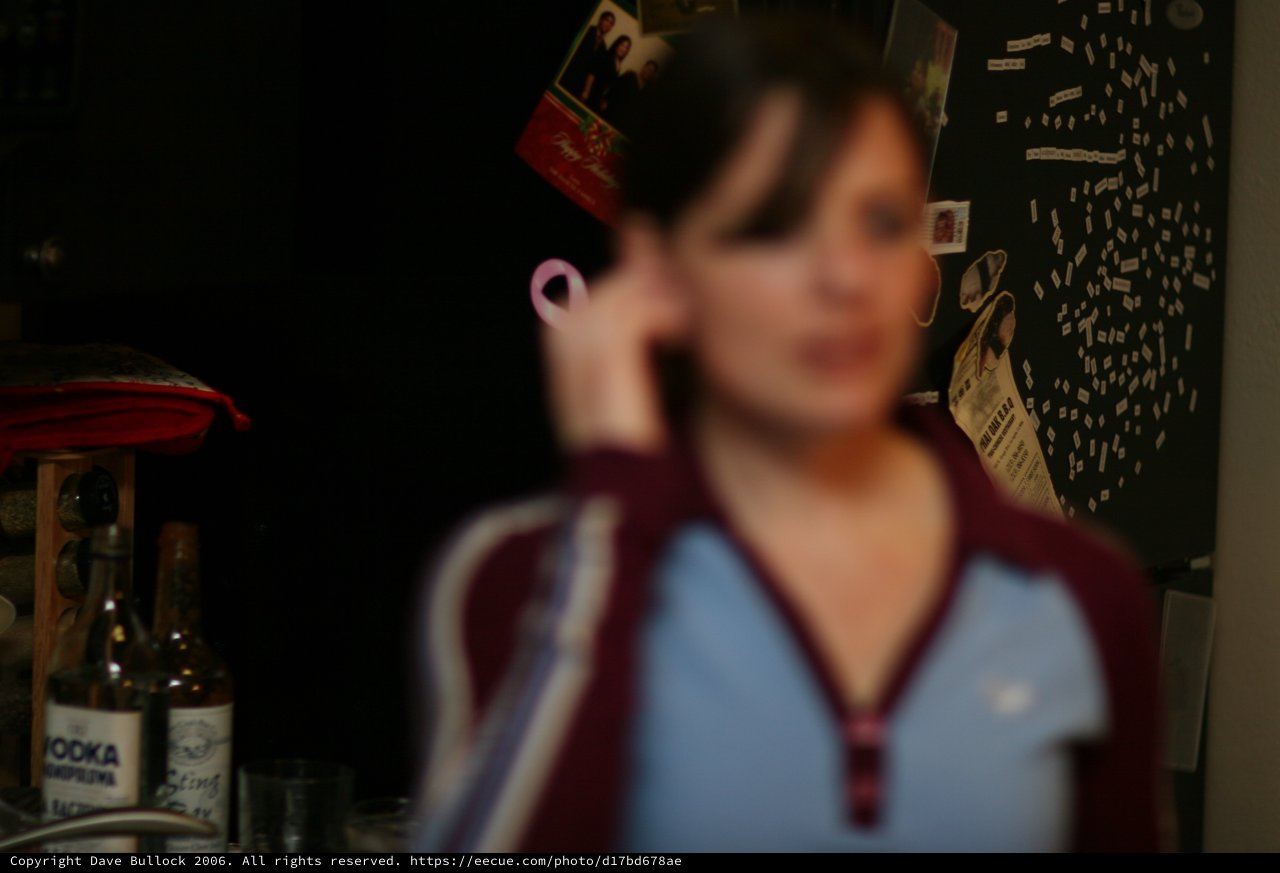 Blurred Portrait of Woman on Phone at Night
