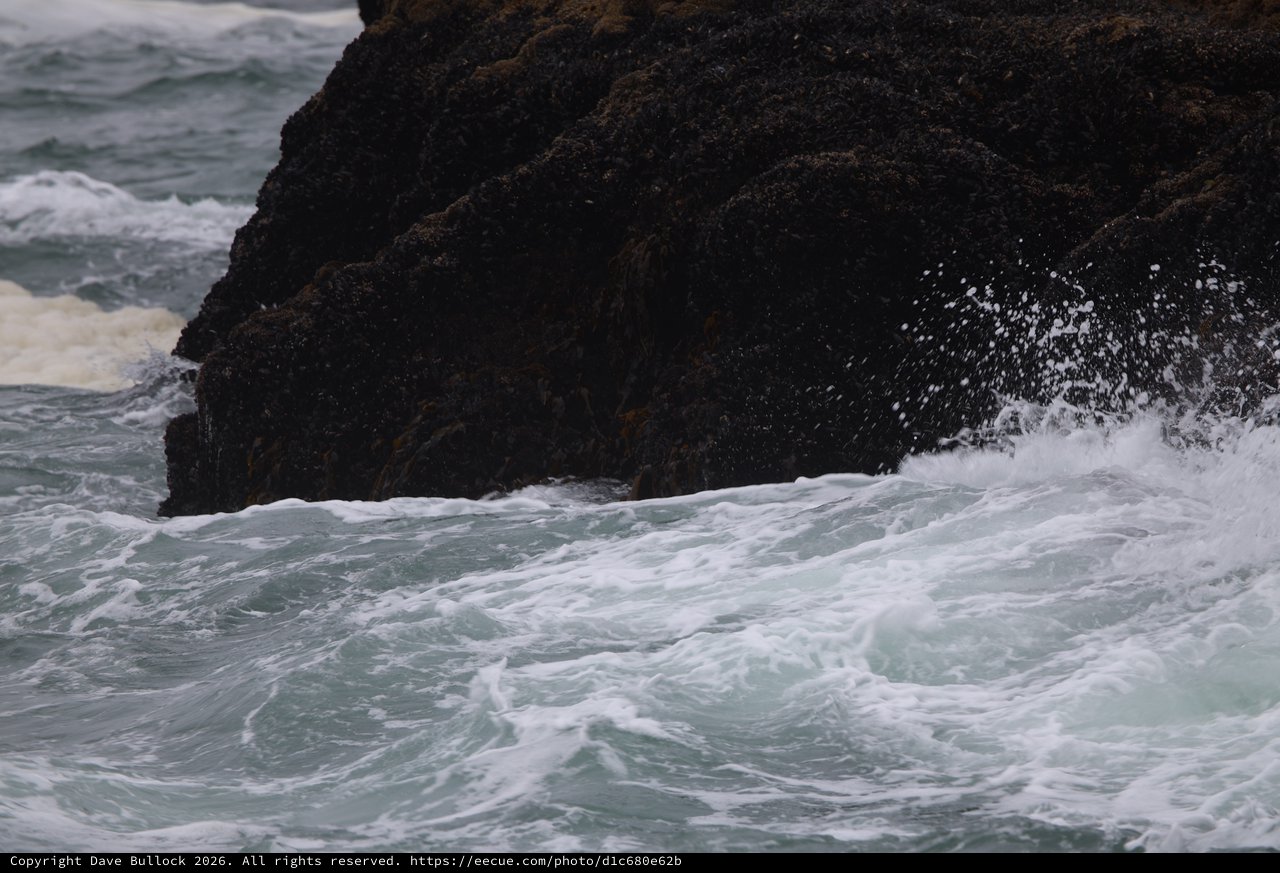 Furious Waves Crash Against Dark Coastal Rock