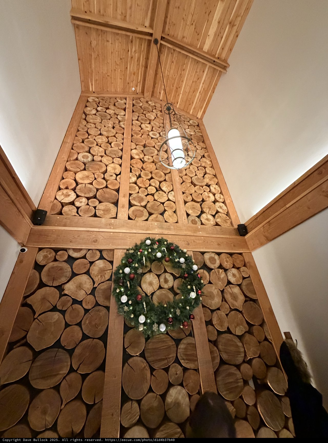 Cross-Cut Log Wall with Festive Christmas Wreath