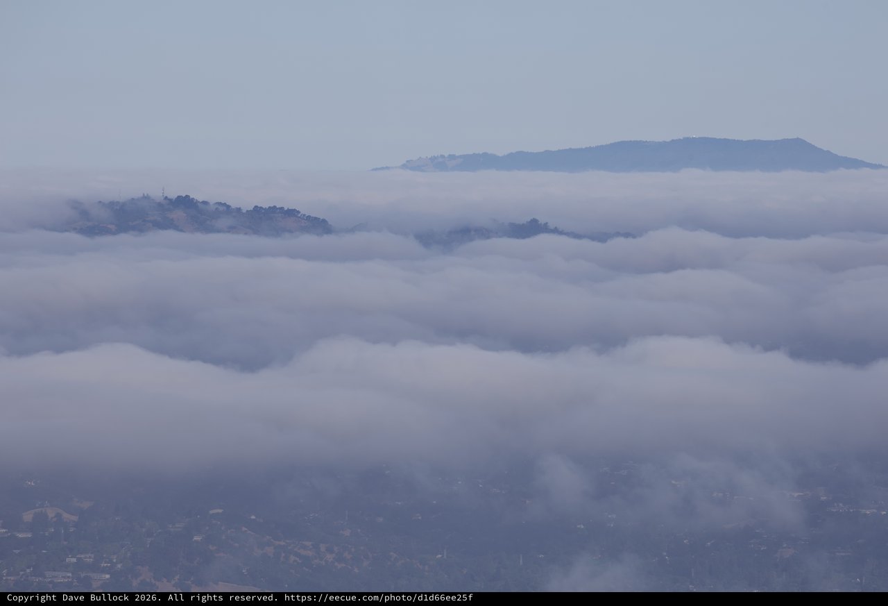 Hills Emerging Through Layered Marine Fog Banks