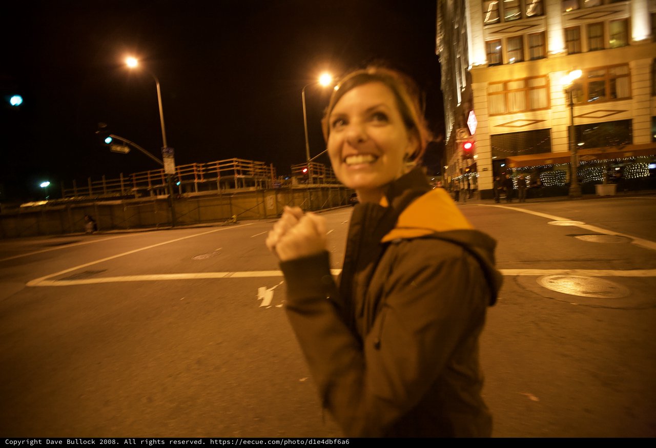 Joyful Woman Celebrating on City Streets at Night