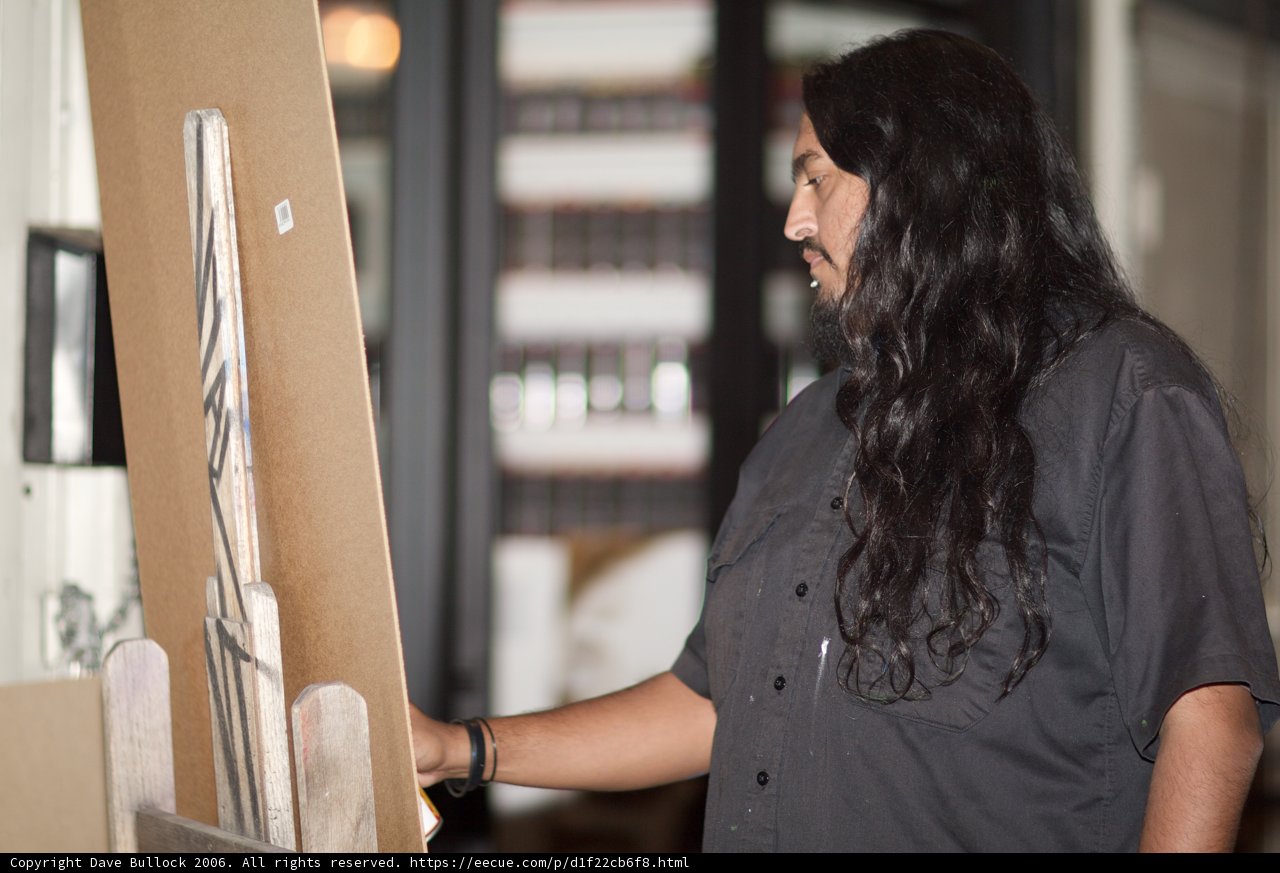 Man with Long Hair Holding a Painting
