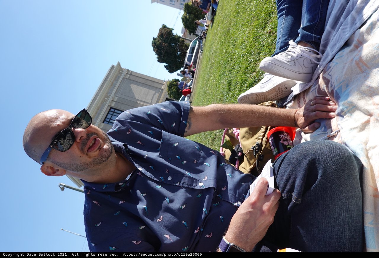 Man Relaxing at Outdoor Gathering in Park