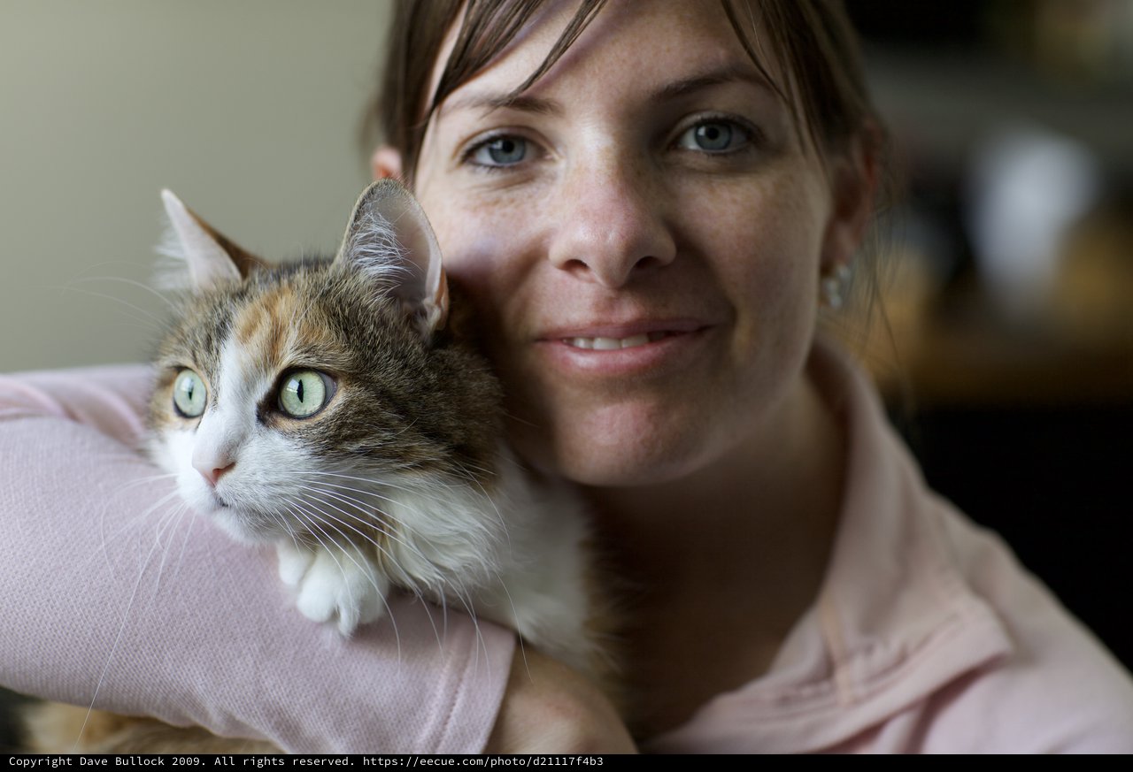 Woman and Calico Cat Share a Tender Moment