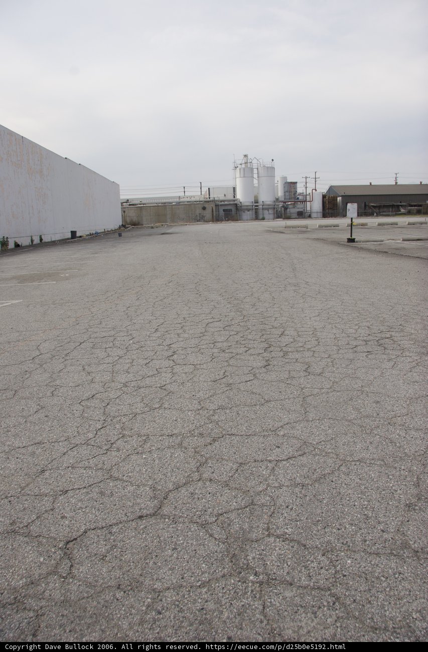 Abandoned Parking Lot with Factory Views
