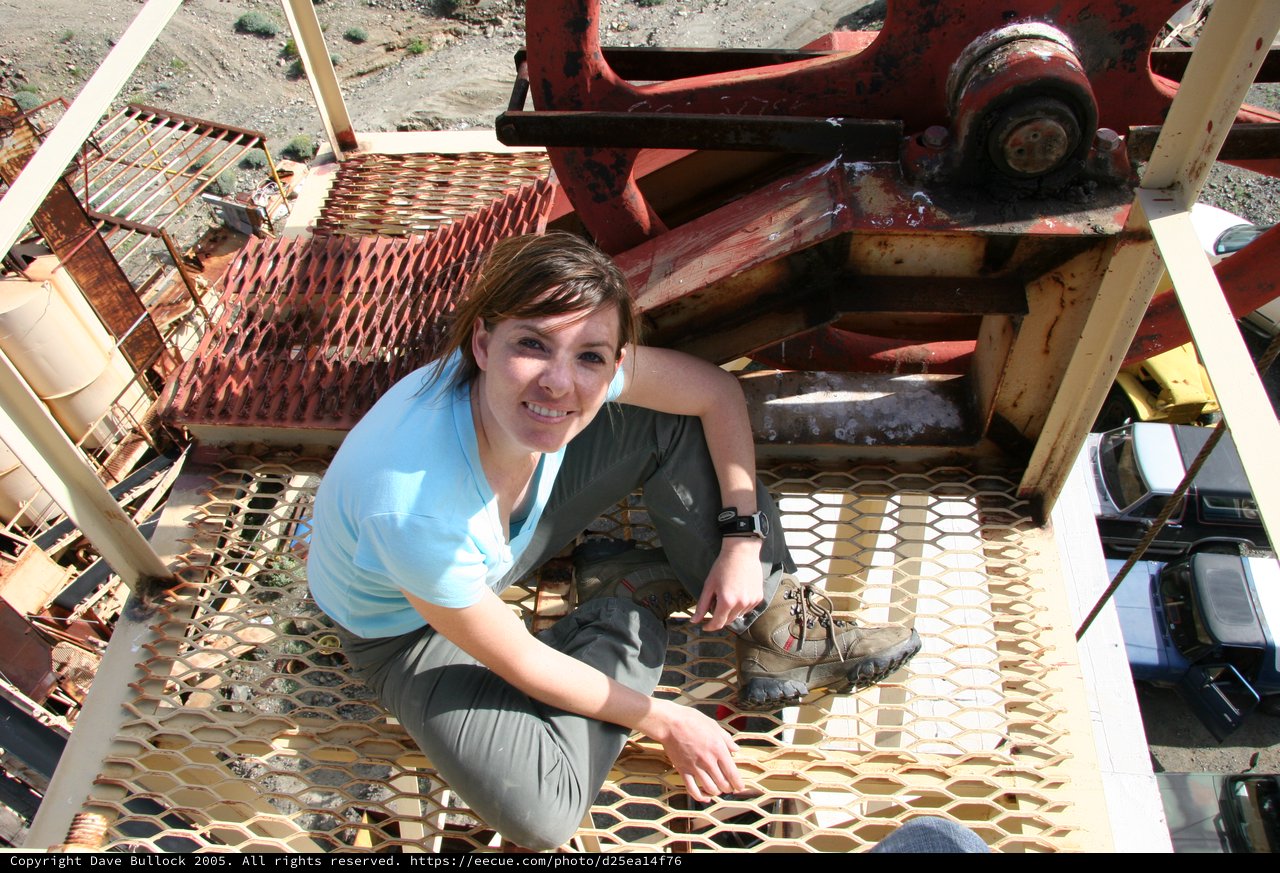 Woman Exploring Abandoned Industrial Mining Structure