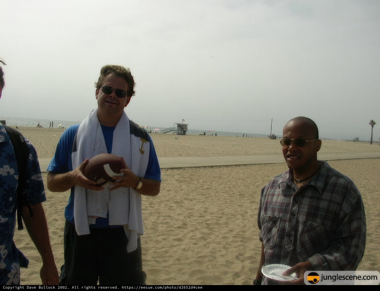 Three Men Enjoying Beach Football Game