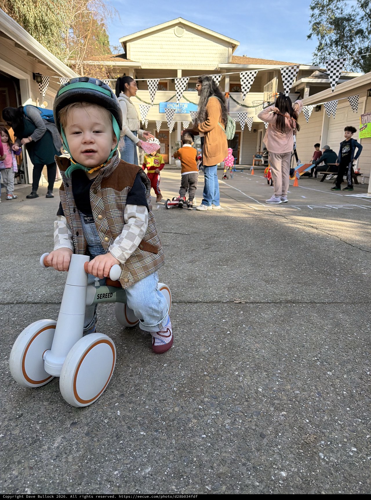 Young Child on Balance Bike at Neighborhood Party