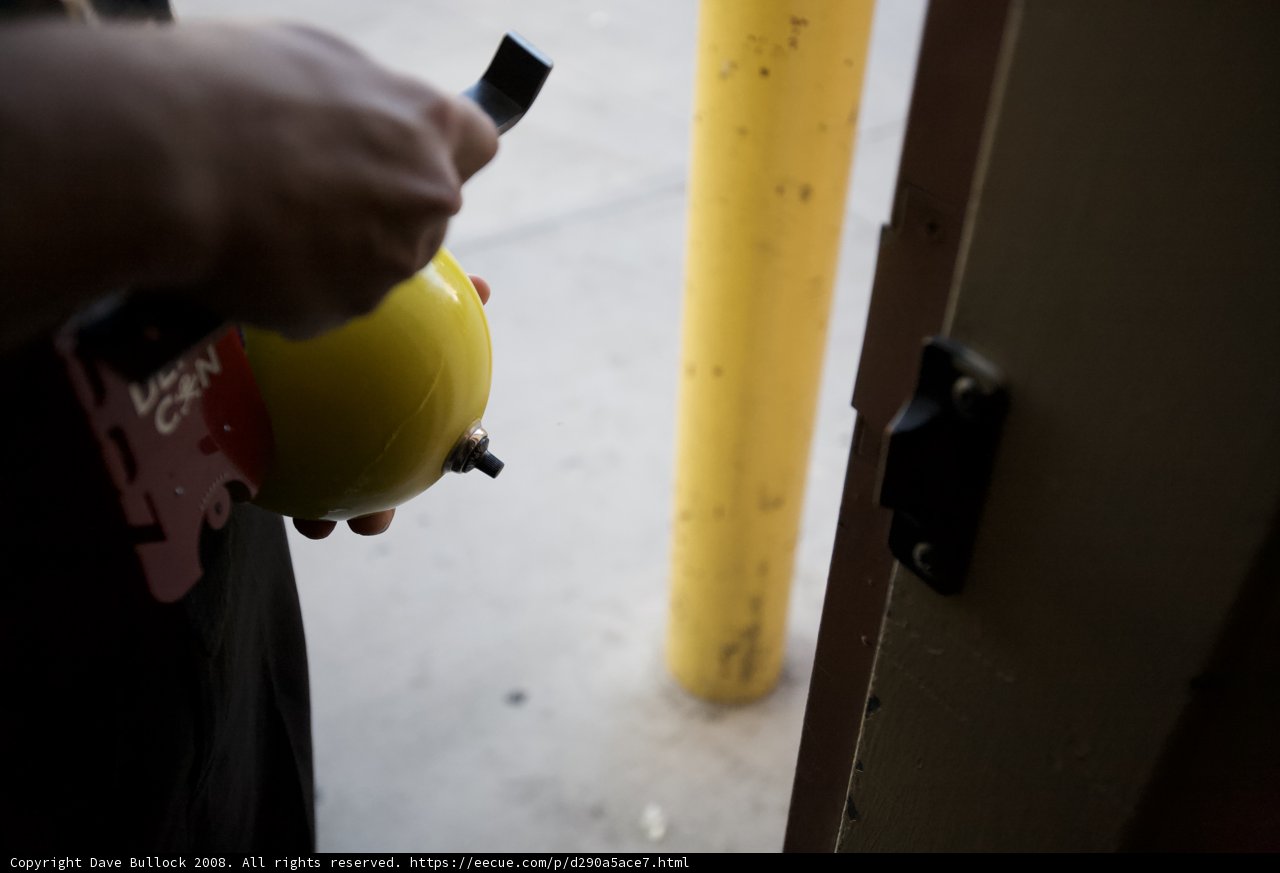 Worker in Hardhat Holds Unknown Object