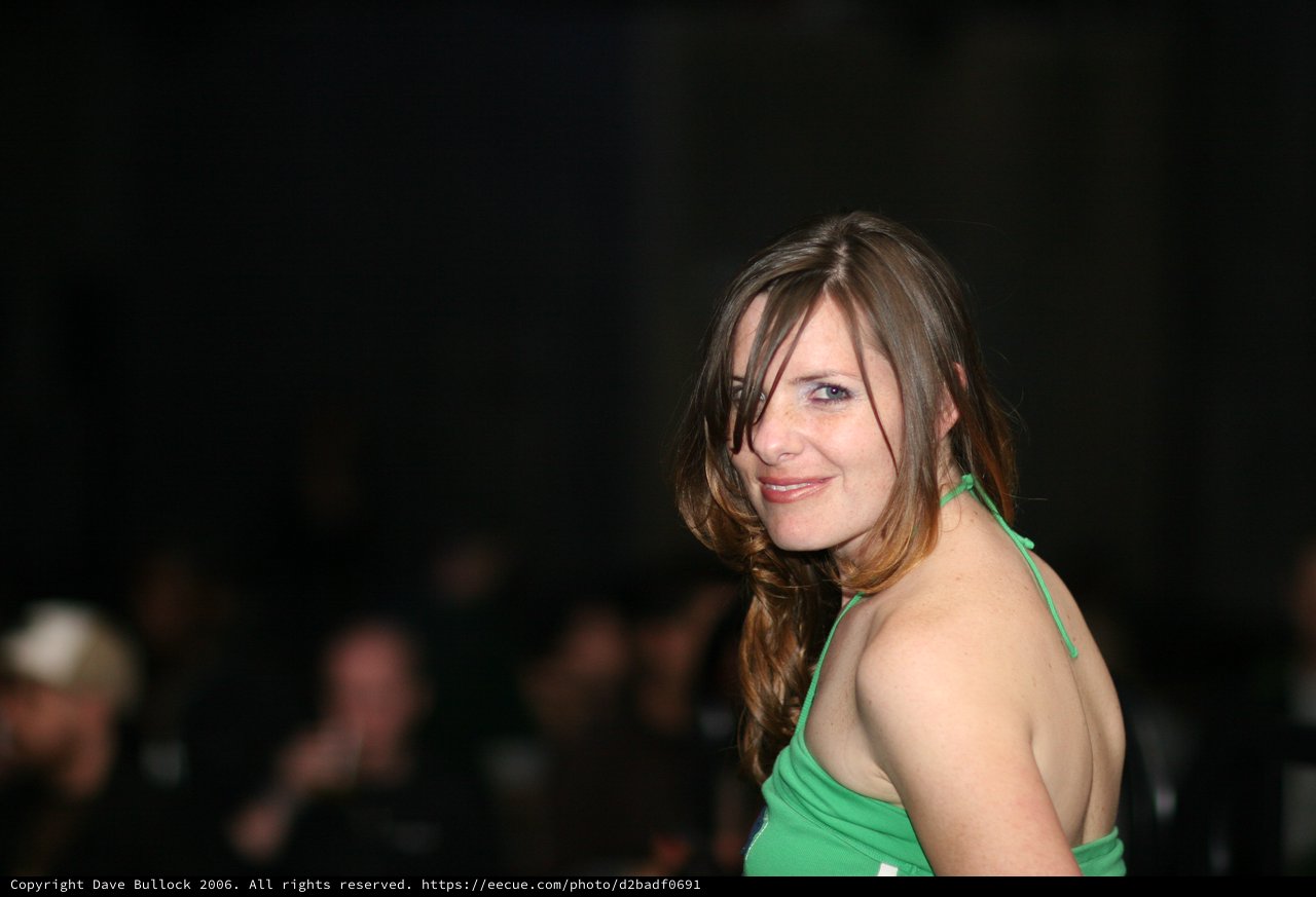 Woman in Green Halter Glances Back at Camera