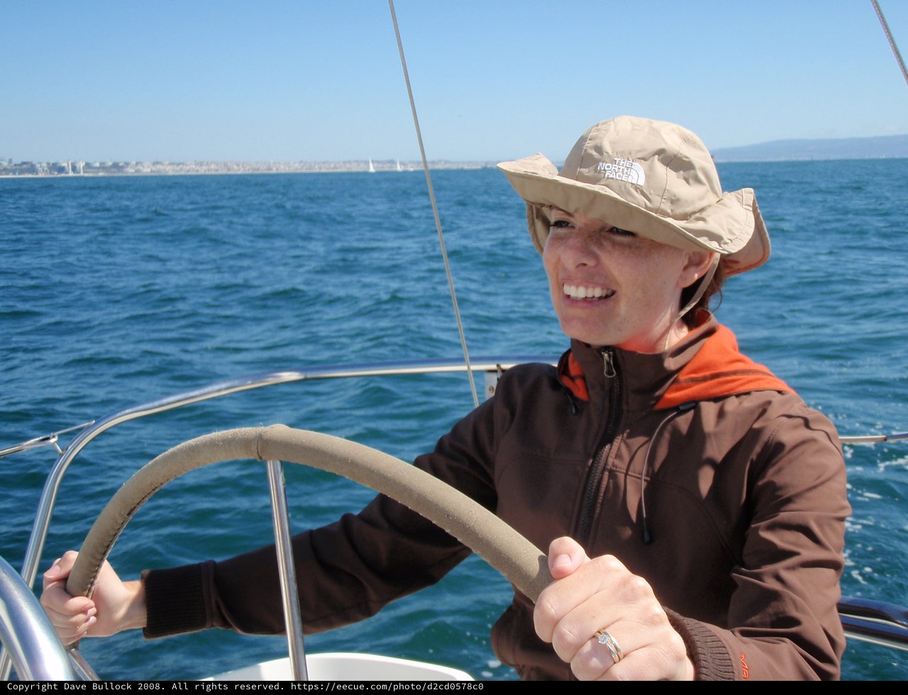 Woman at the Helm on a Sunny Sailing Day