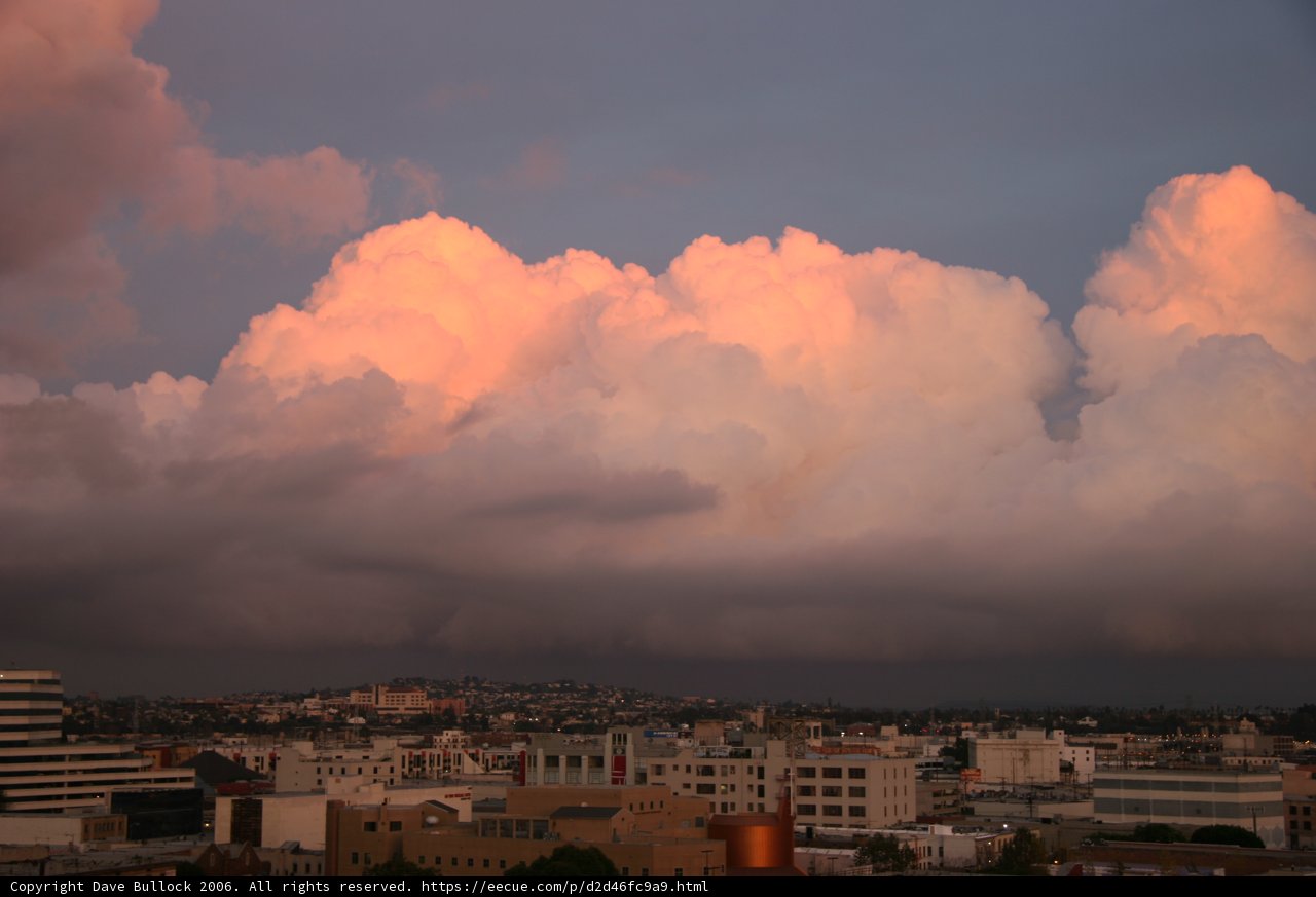 Cityscape under dramatic cumulus clouds