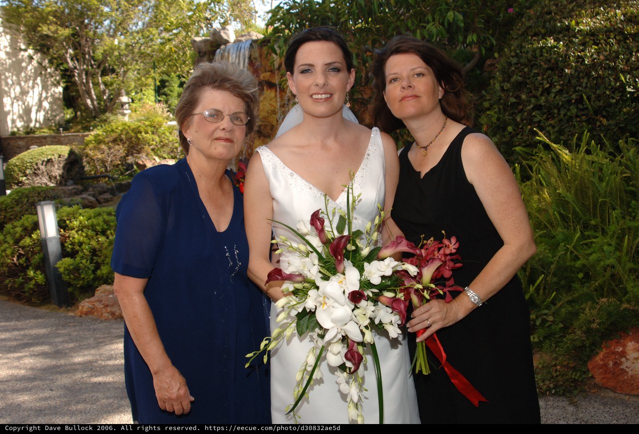 Bride Poses with Family at Outdoor Wedding Venue