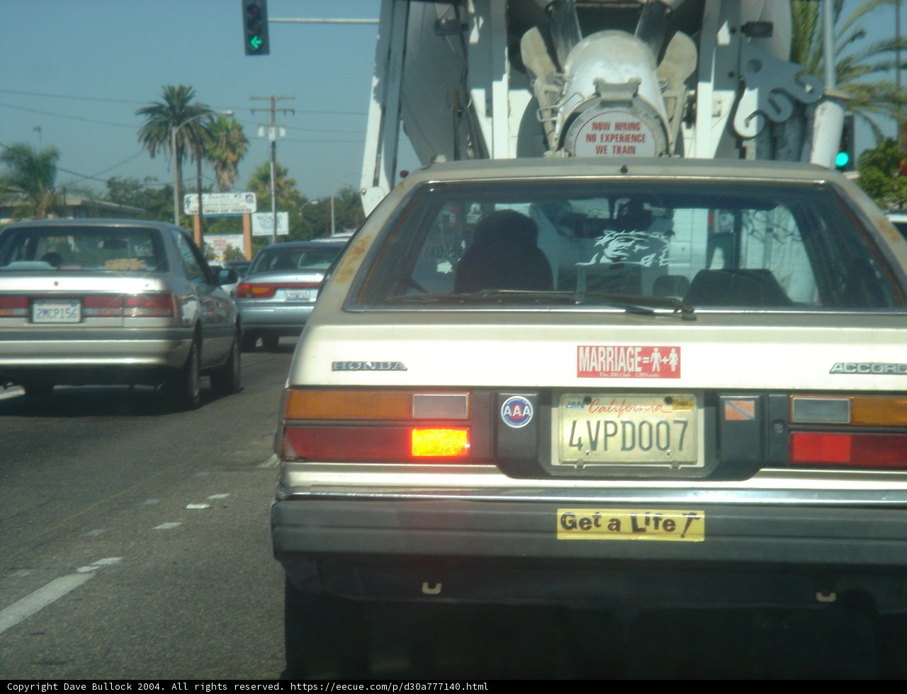 White Coupe with a Palm Tree Sticker
