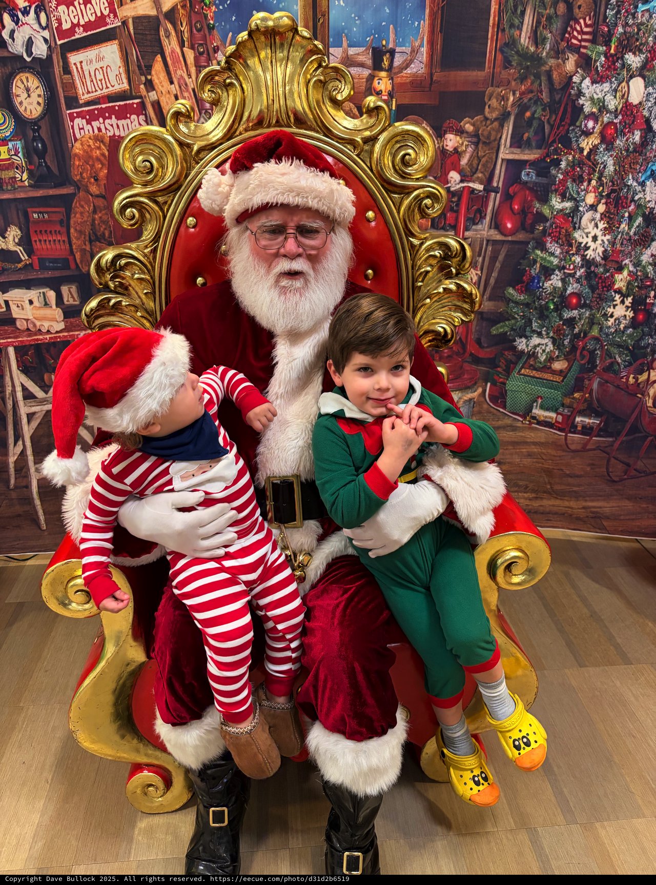 Two Children Visit Santa in His Workshop Throne