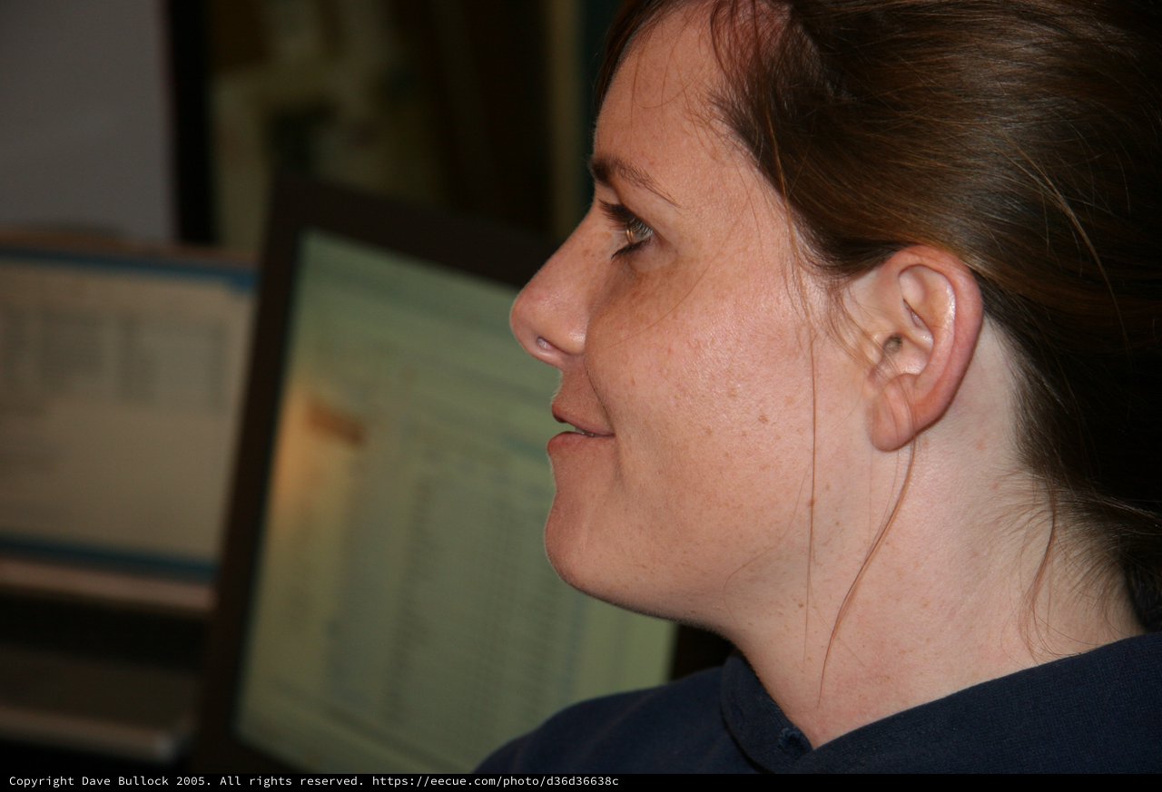 Woman in Profile Gazing at Computer Screen