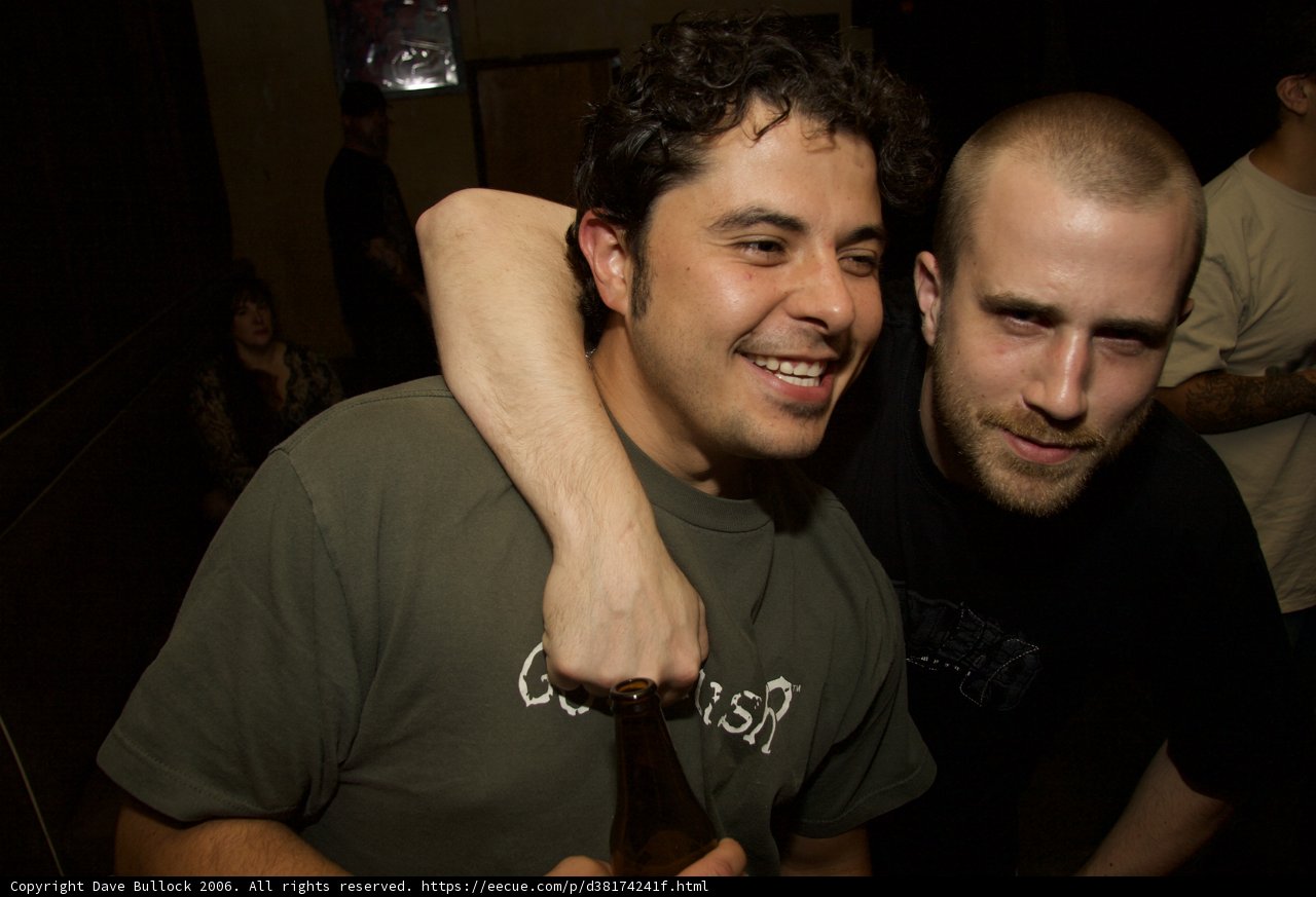 Green-shirted man enjoying a night out with friends