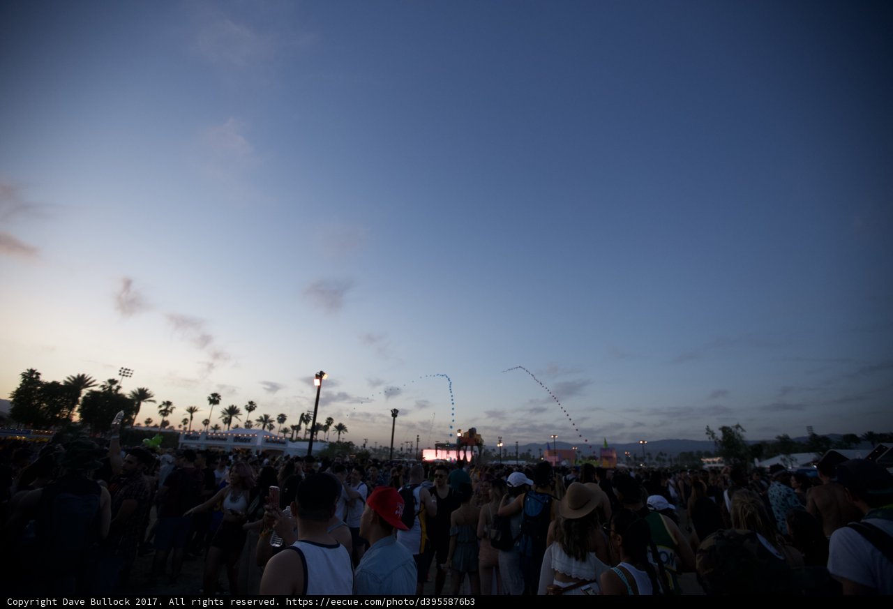 Music fans under a cloudy sky
