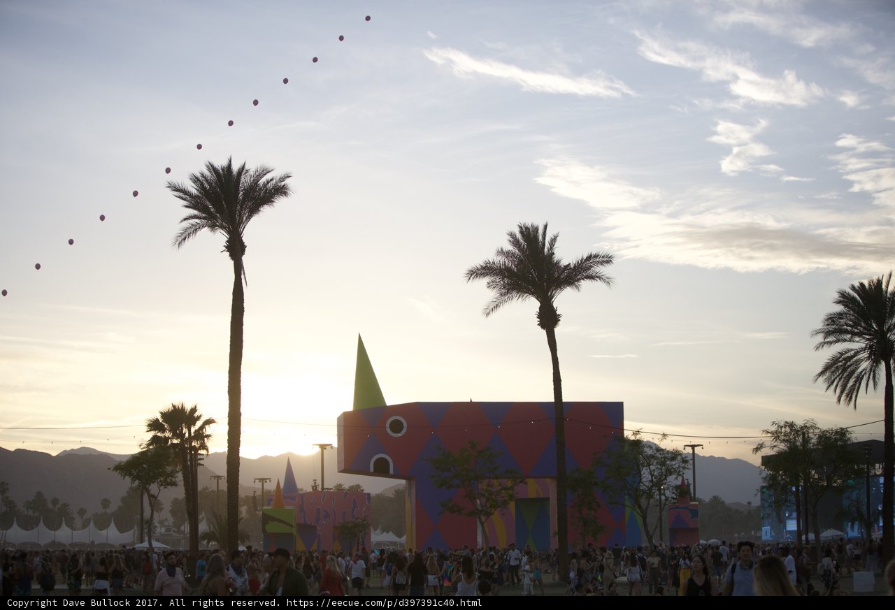 Sunset Crowd Gathering around a Tropical Building