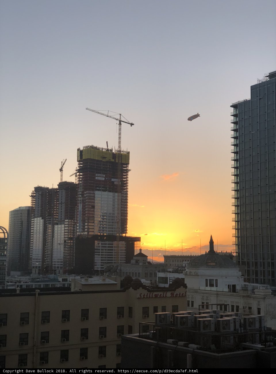Crane Takes Flight in the Sunset Skyline