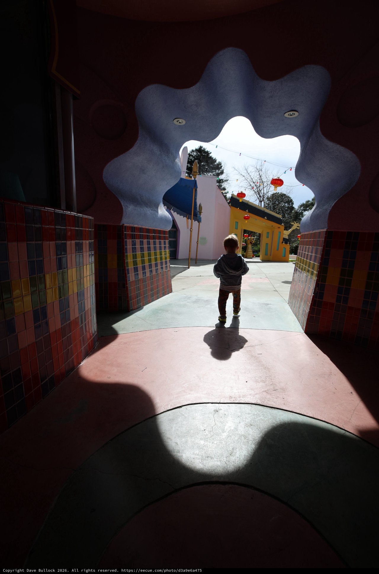 Child Approaching Whimsical Portal in Colorful Passage