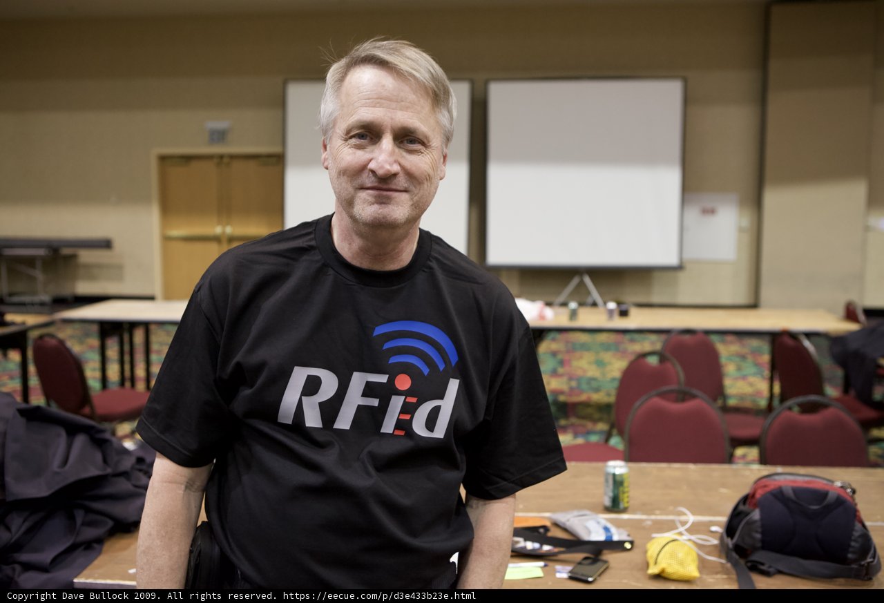 Man in Black Shirt Standing in front of Table