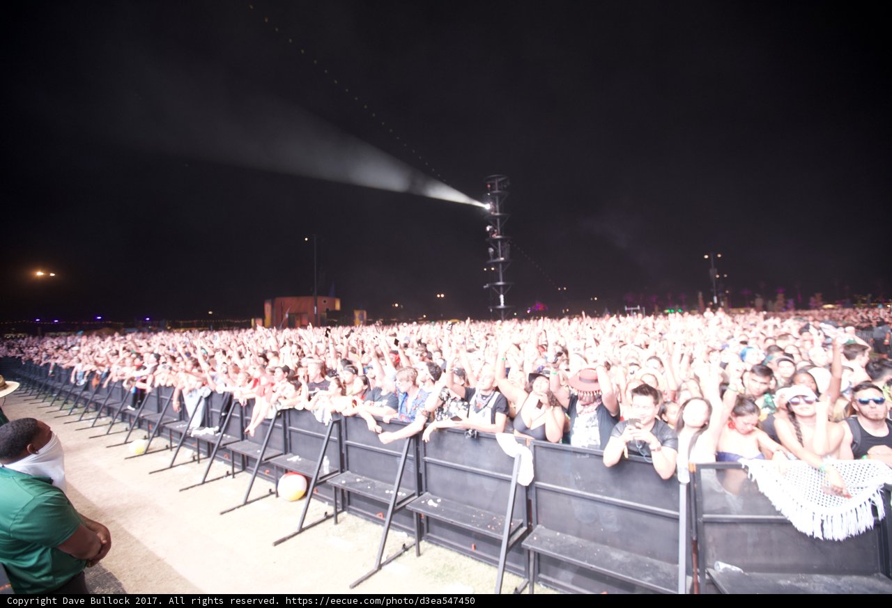 Man standing amidst a sea of fans at Coachella concert