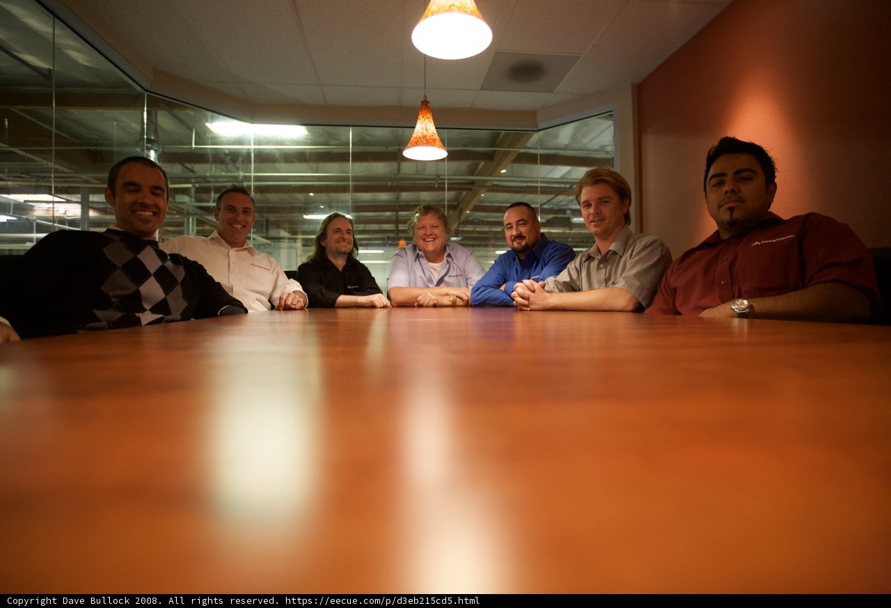 Artie P and colleagues hold a meeting in the wooden-floored office