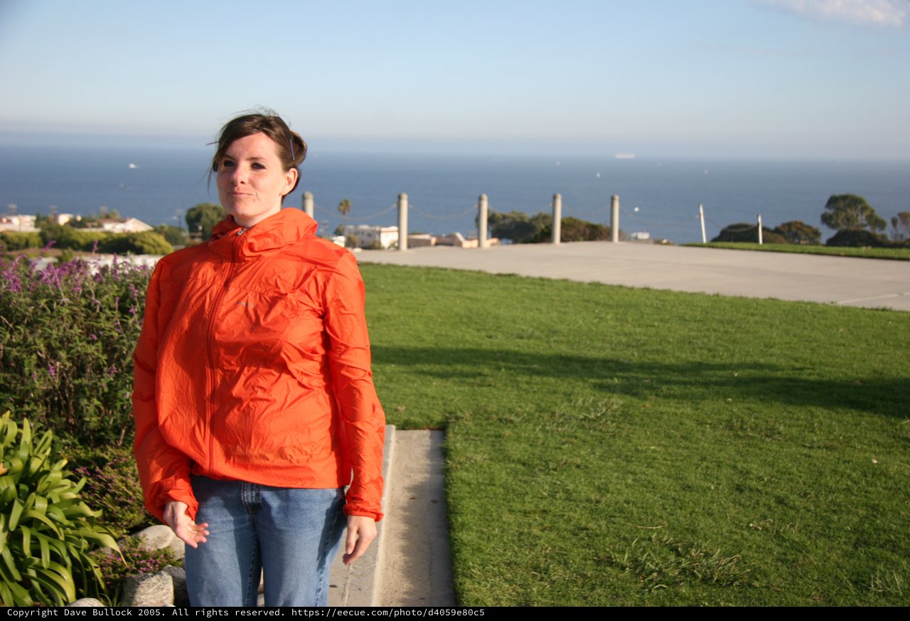 Woman in Orange Jacket by the California Coast