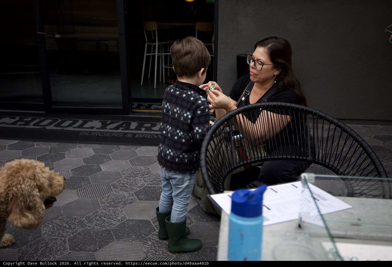 Mother and Child Moment at Outdoor Cafe