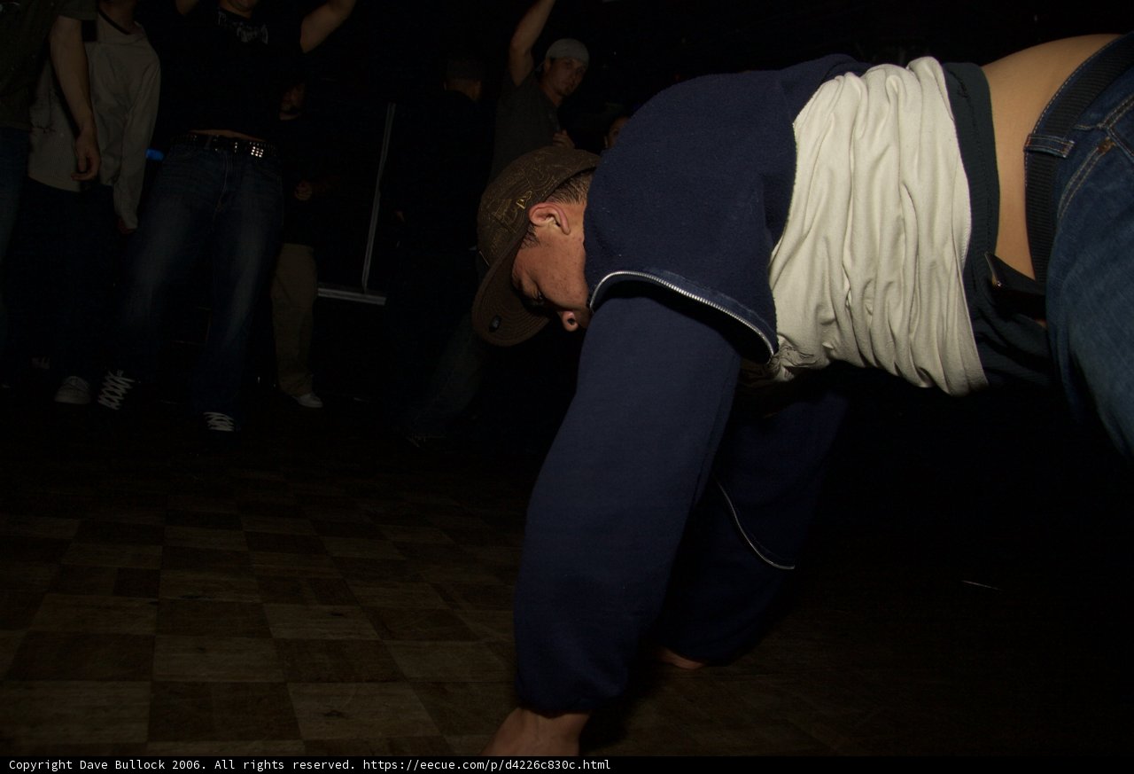 Blue-shirted Man with Hats and Shorts Tagged in 2006 Muse Album