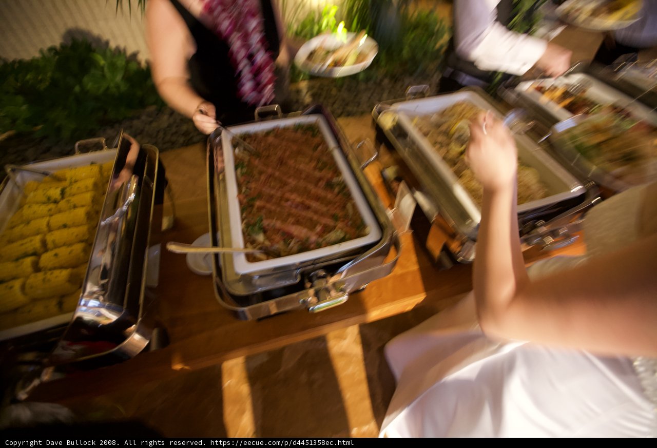 Enjoying A Delicious Meal At A Buffet Table