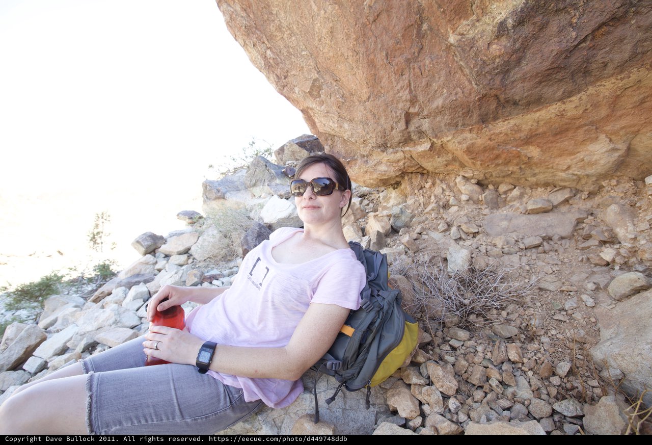 Desert Hiker Resting in the Shade of a Rocky Overhang