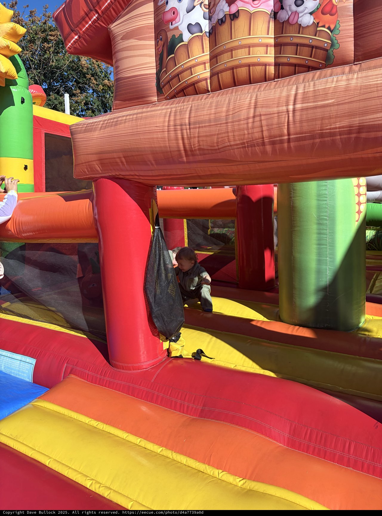 Child Playing on Colorful Inflatable Bounce House