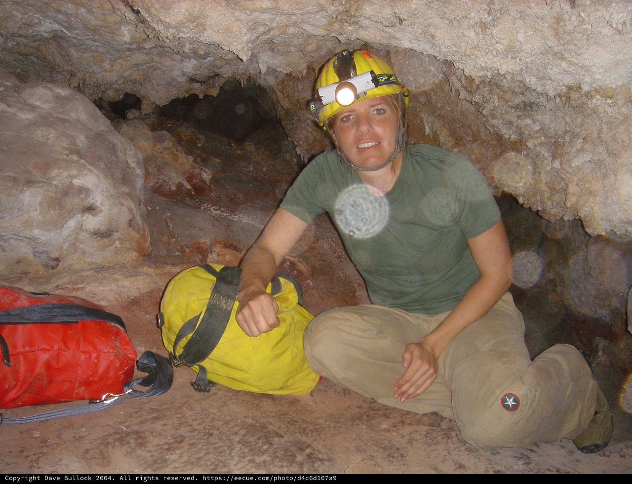 Cave Explorer Navigating Tight Underground Passage