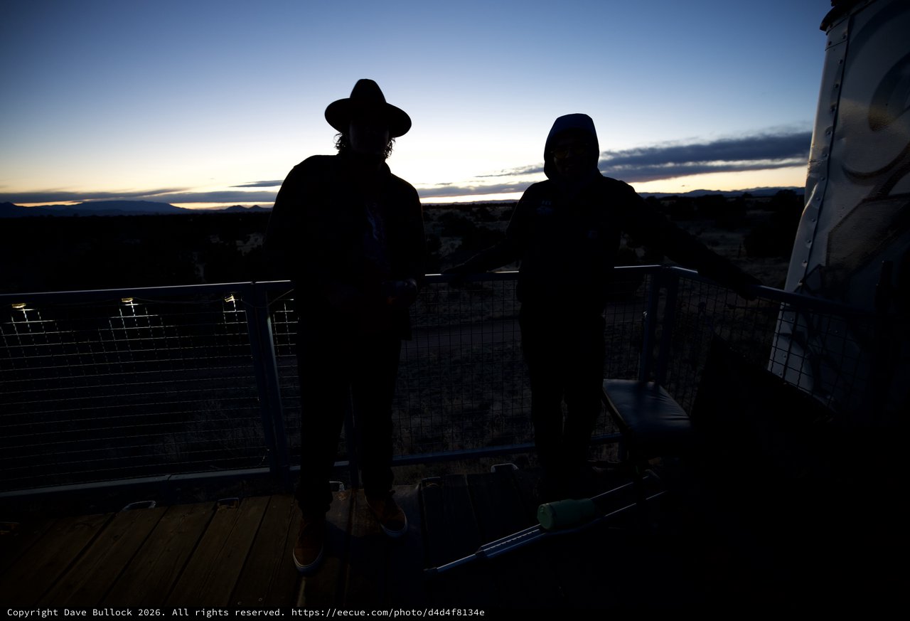 Twilight Contemplation: Silhouettes Against Desert Sunset