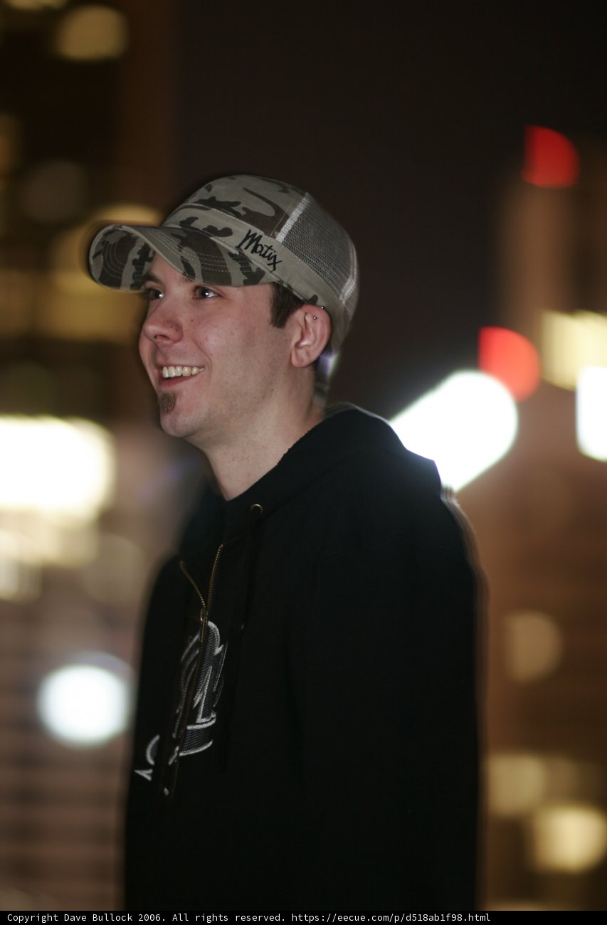 Smiling Man in Baseball Cap and Hoodie