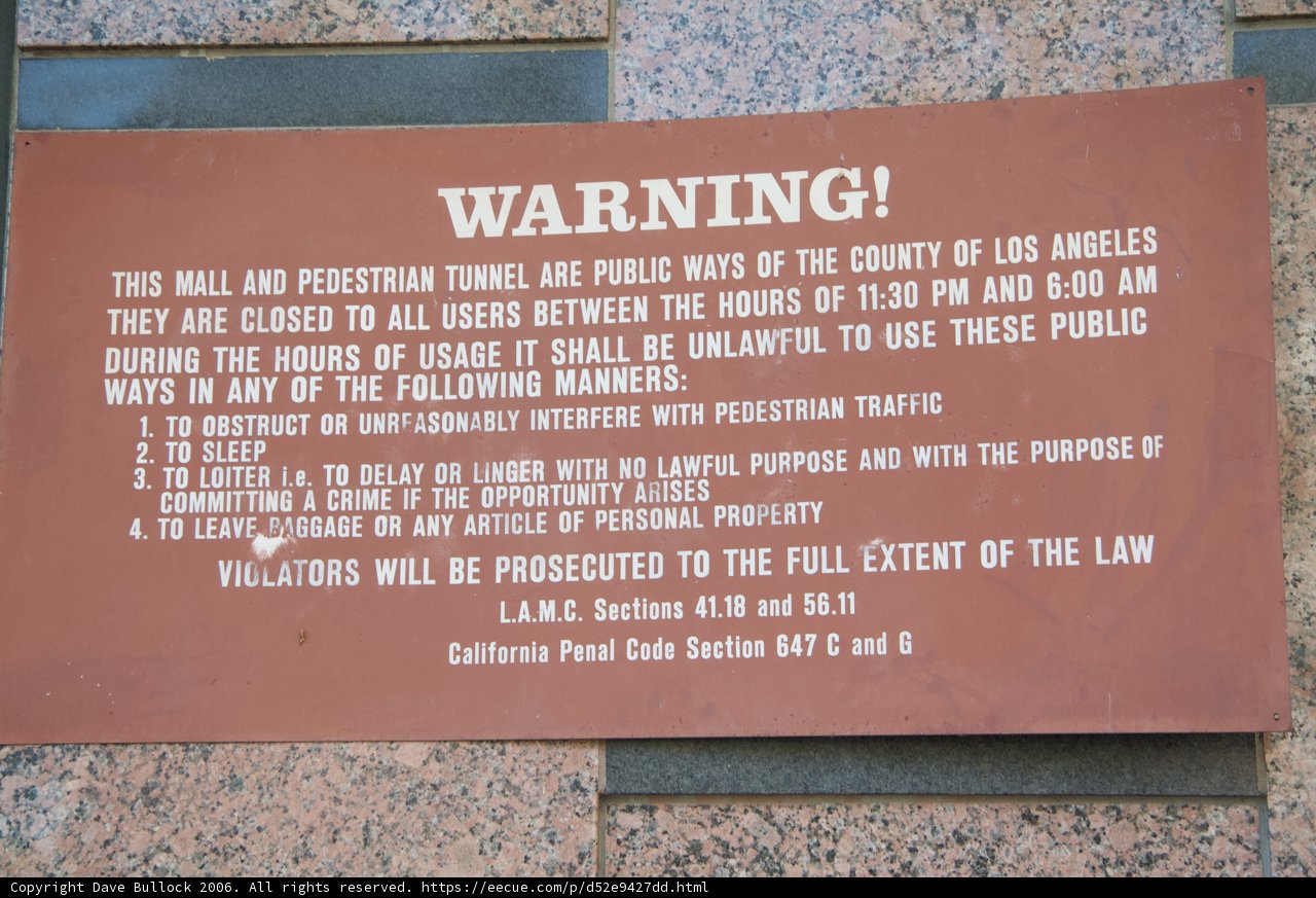 Warning Plaque on Building Wall