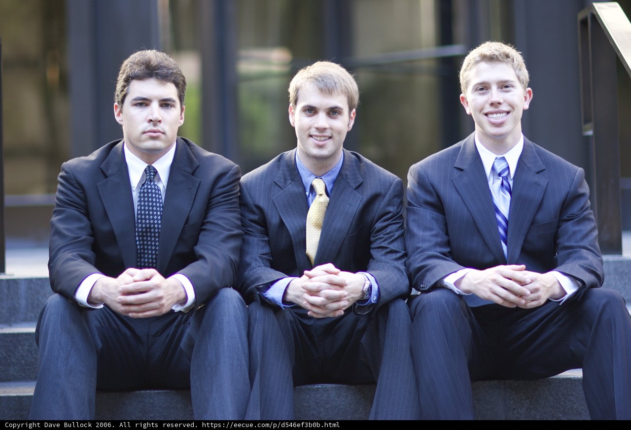 Three Men in Suits Sitting on Steps