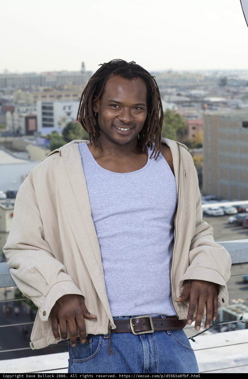 Dreadlocked Man on Balcony